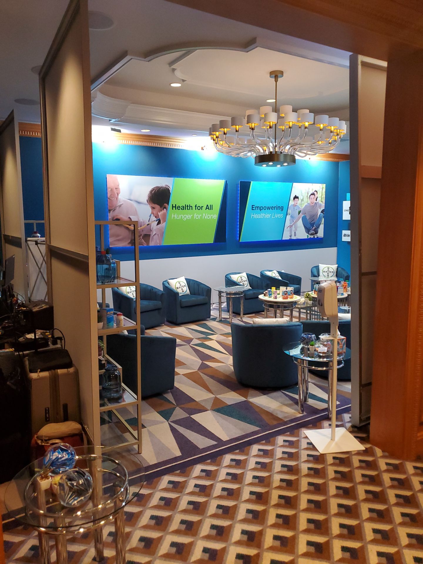 Annual Meeting suite — entrance view through doorway showing the full branded environment