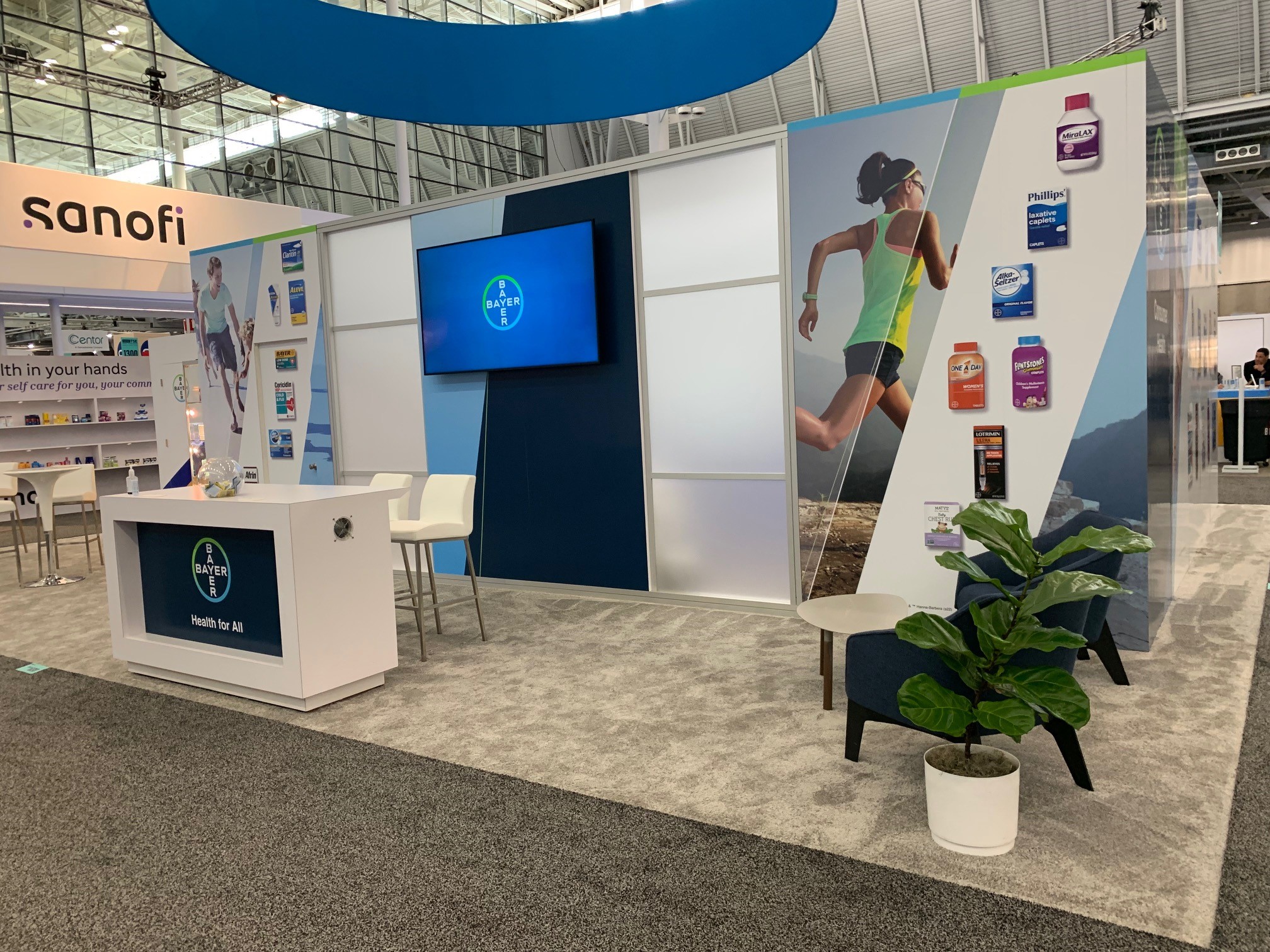 Bayer NACDS trade show booth with competitor visible — spatial exhibition design